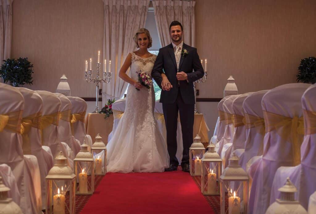 Bride and groom standing at the end of the aisle at their civil ceremony