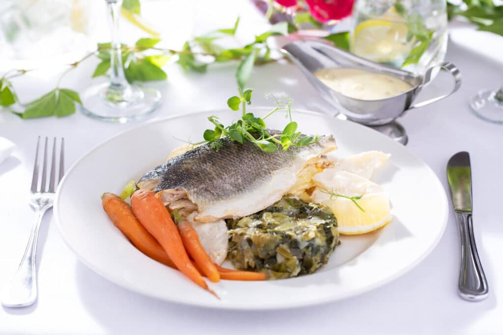 Cooked fish meal with lemon and carrots