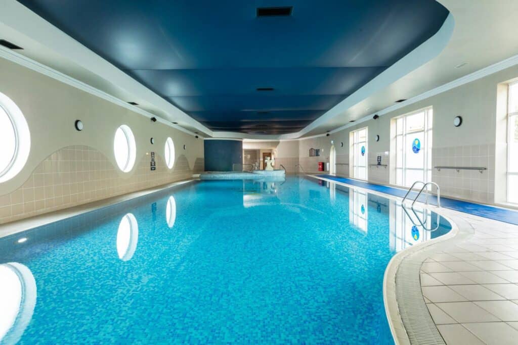 Indoor swimming pool with natural light from windows