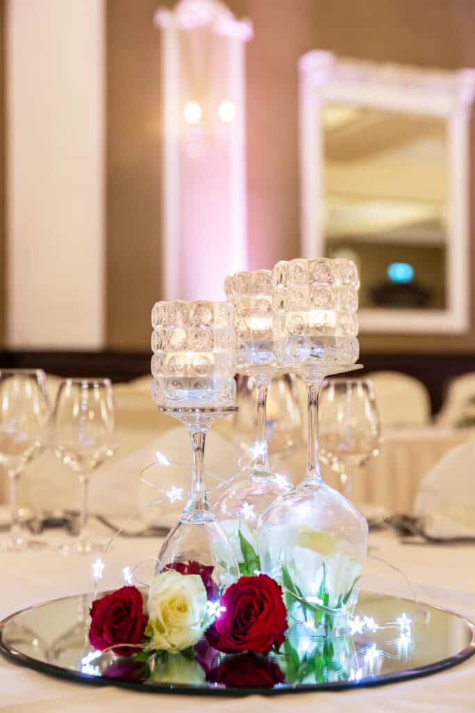 Intricate candles displayed on top of wine glasses