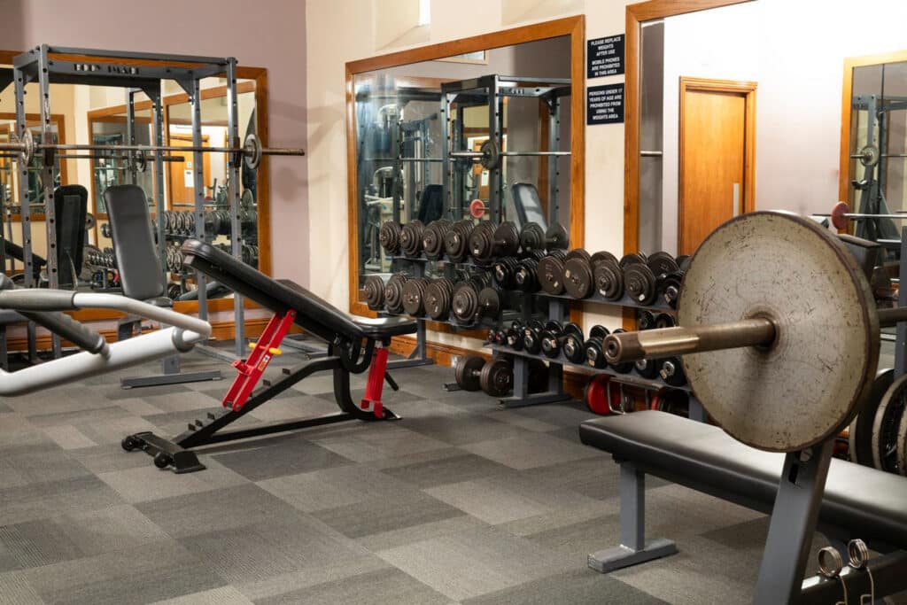 View of the gym of the bench press with weights stacked up