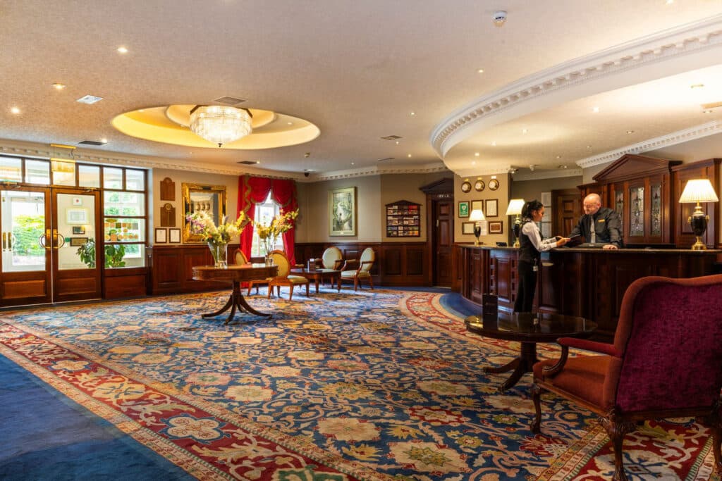 View of the lobby area at The Seven Oaks Hotel and Leisure Club with lady talking to receptionist